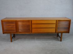 An A H McIntosh & Co Ltd 1960s teak sideboard, with three central short drawers, the top drawer