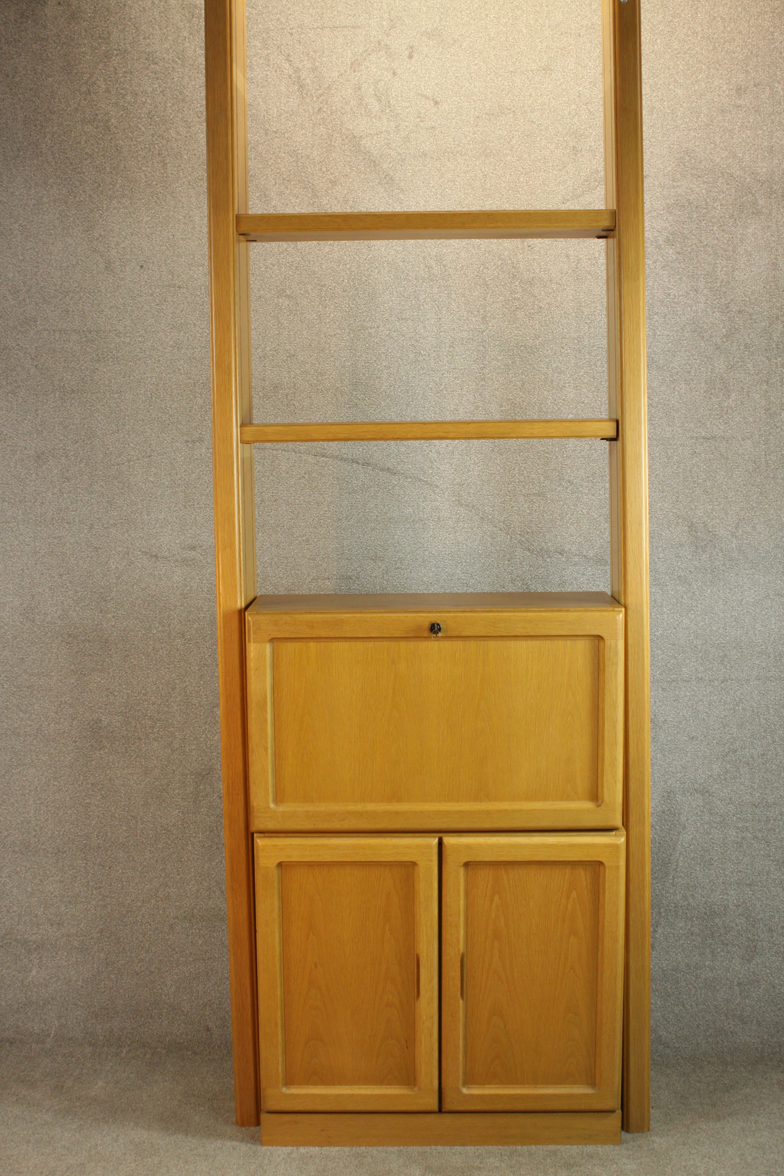 A late 20th century oak bureau cabinet, with shelves over a fall front containing drawers,