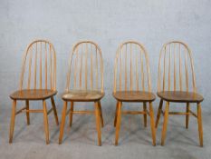 A set of four 20th century Ercol style blond elm hoop back Windsor dining chairs.