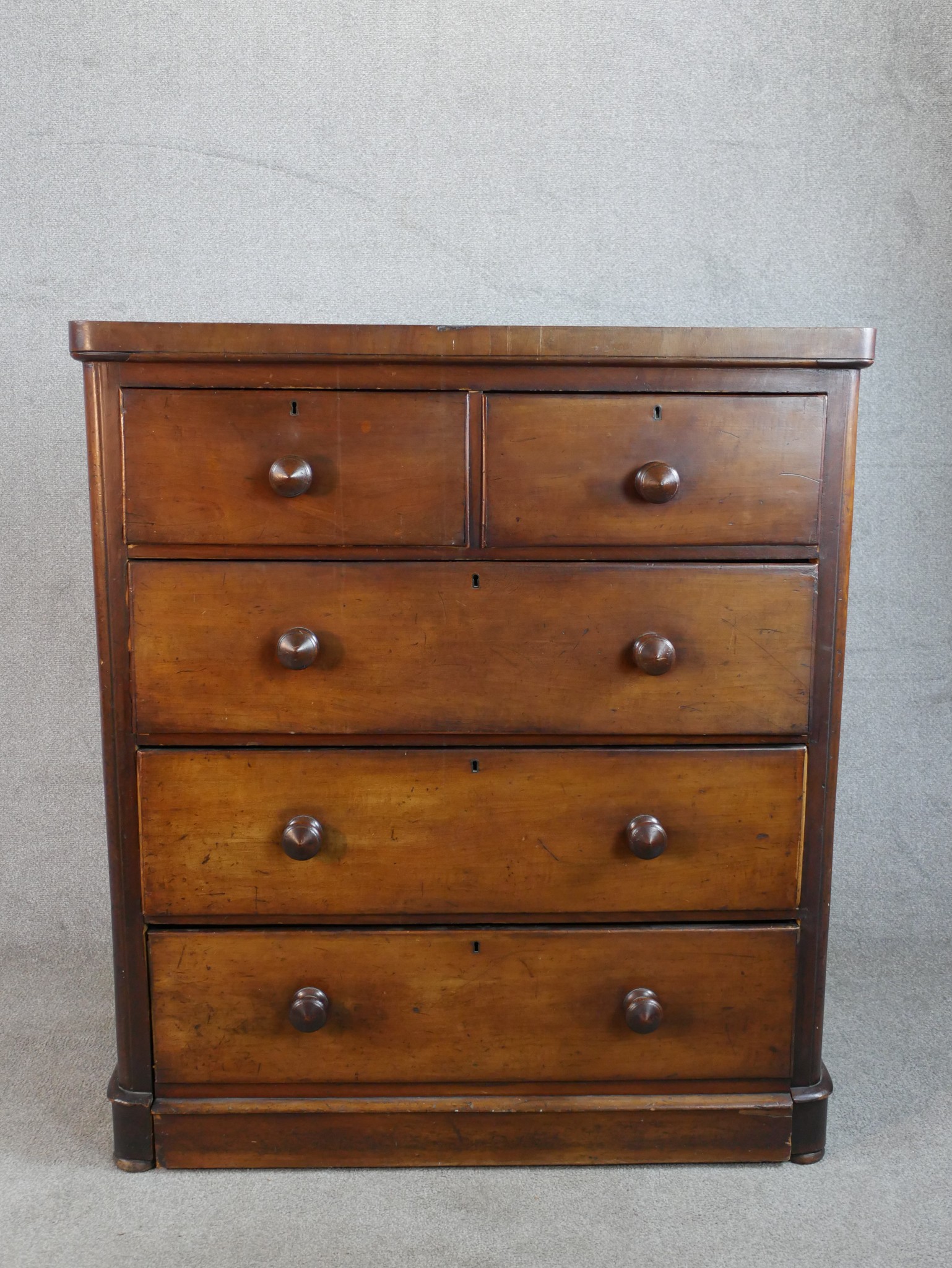 A late 19th / early 20th century mahogany chest of two short over three long drawers with turned