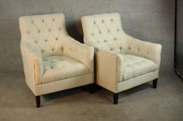 A pair of early 20th century mahogany framed button upholstered armchairs raised on tapering
