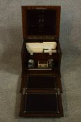 A 1930's oak fold out writing box opening to reveal fitted interior complete with various papers and