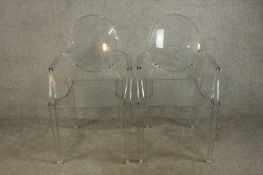 A matching pair of Philippe Stark Kartell Louis Ghost Christal open arm chairs raised on square