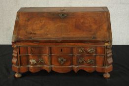A 19th century apprentice walnut Dutch style fall front writing bureau with fitted interior on two