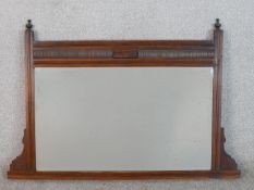 A Victorian Aesthetic style walnut overmantel mirror, with a rectangular bevelled mirror plate,