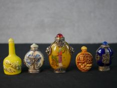 Five Chinese 20th century snuff bottles, including a reverse painted glass bottle with geisha design