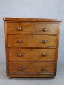 A late 19th / early 20th century mahogany chest of two short over three long drawers with turned