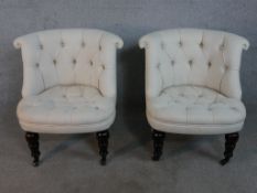 A pair of contemporary 19th century style tub chairs, upholstered in cream coloured buttoned fabric,