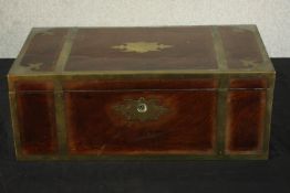 A late 19th century mahogany and brass bound fold over writing slope opening to reveal a fitted