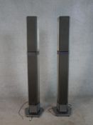 A pair of contemporary Bang & Olufsen floor standing electric speakers, each raised on pentagonal