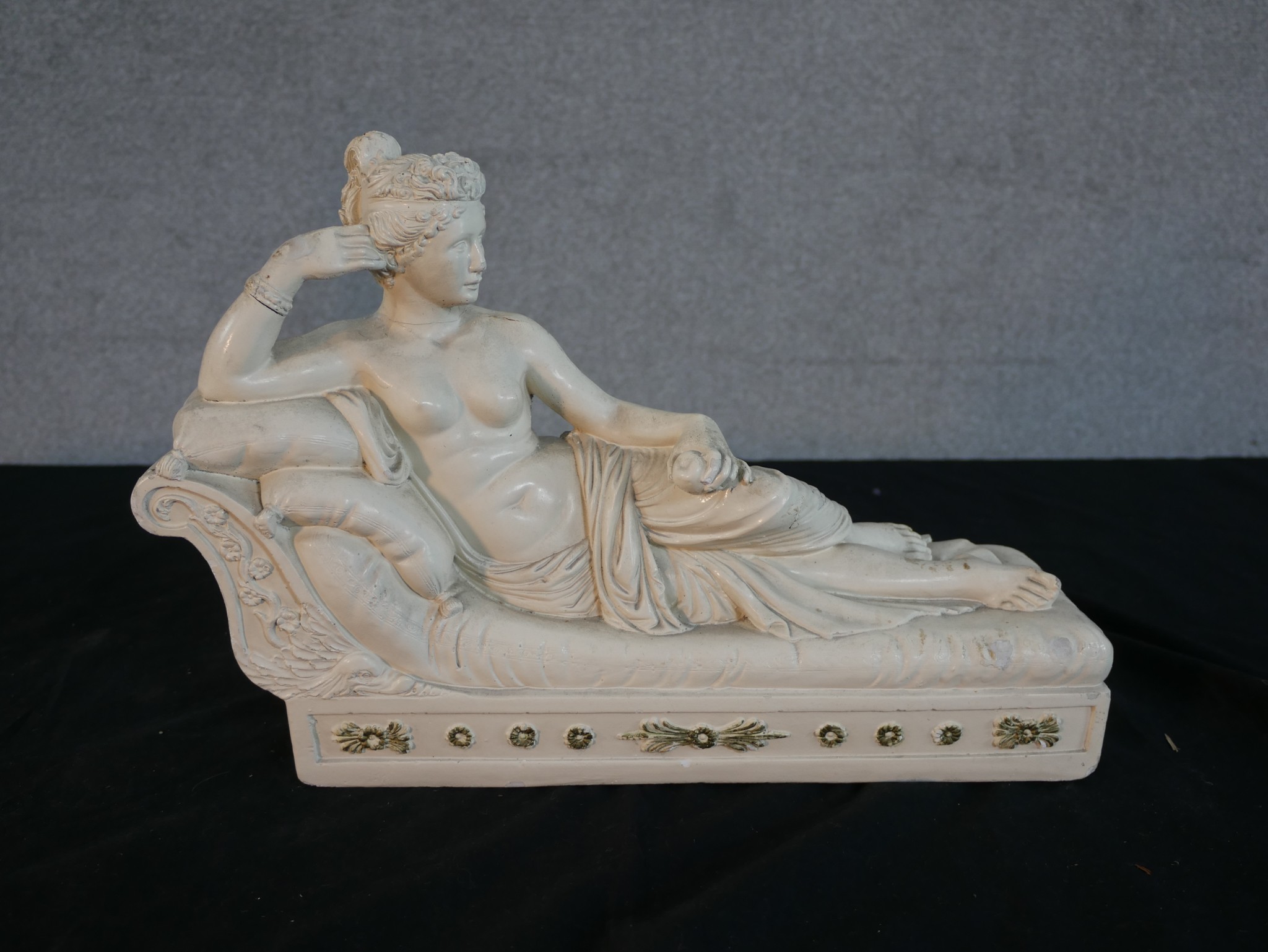 A contemporary plaster figure of a reclining Roman style lady. H.26 W.38 D.11cm