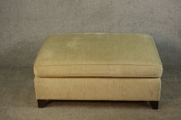 A contemporary mahogany framed foot stool upholstered in cream coloured fabric. H.41 W.100 D.70cm.