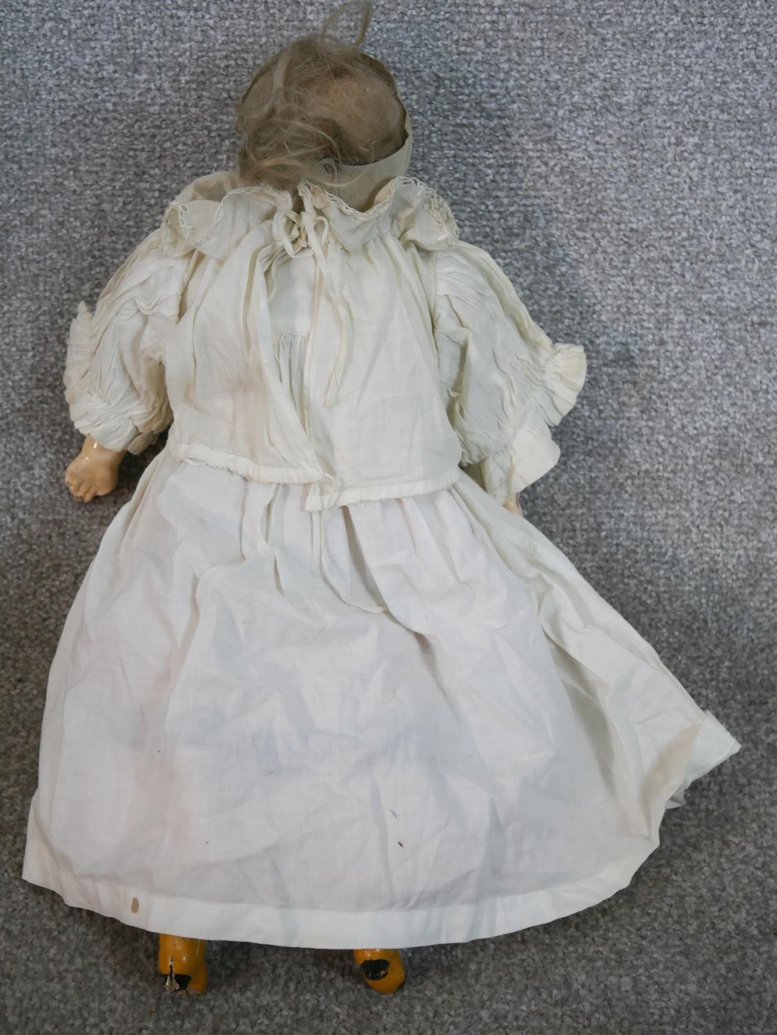 Two 19th century dolls, one craved and painted in a lace bonnet and dress with glass eyes, the other - Image 4 of 6