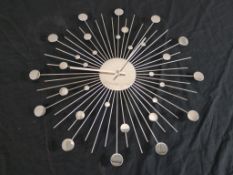 A mid 20th century style polished metal sun or sputnik style wall clock. H.50 W.50 D.1cm