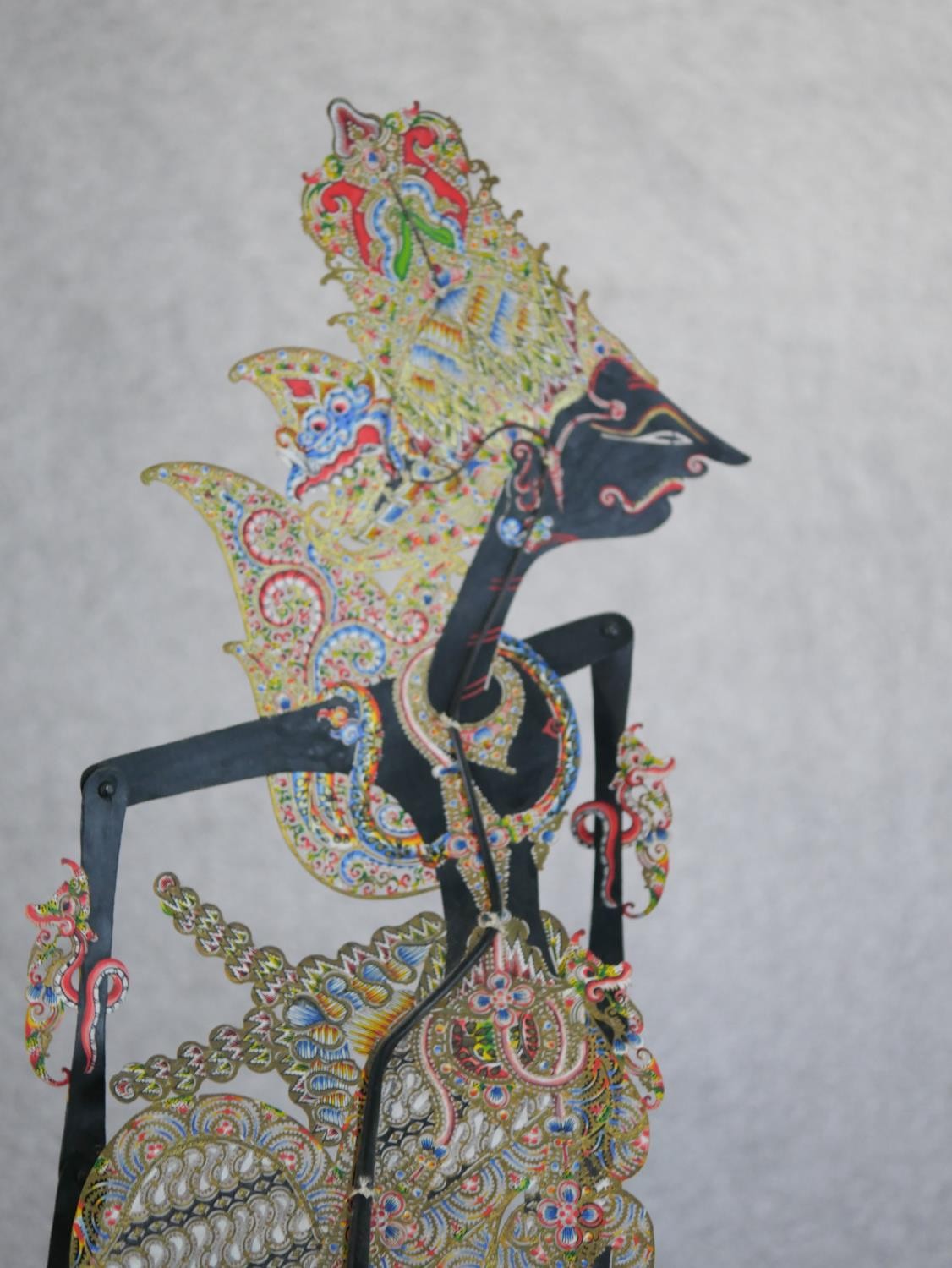 A carved and painted Javanese Wayang shadow puppet doll in silk clothing along with another Javanese - Image 4 of 6