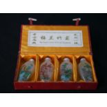 A contemporary set of four painted Chinese glass scent bottles, each painted with various flowers,