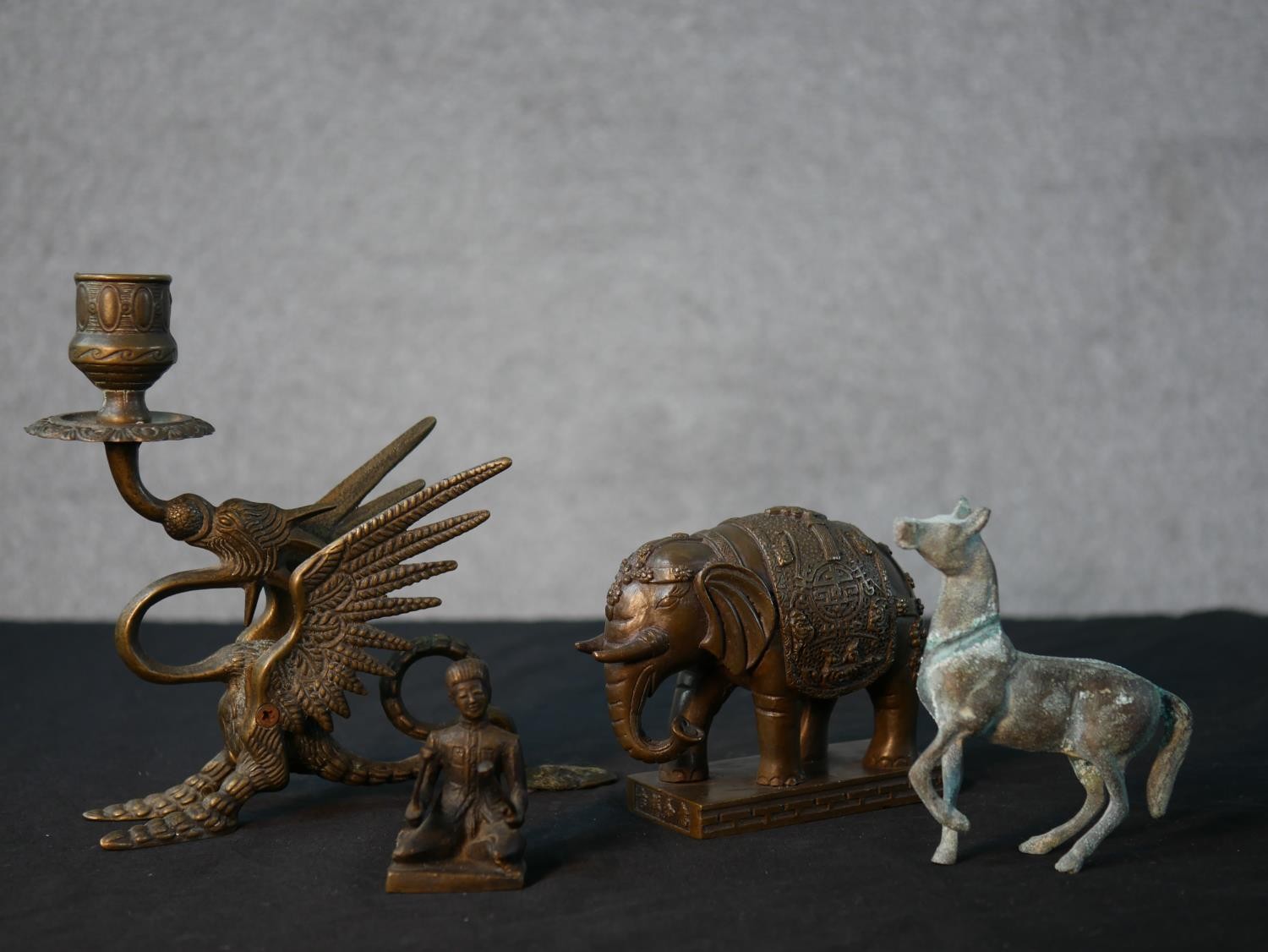 A collection of metalwork figures, including a bronze elephant, a Greek style horse, a Chinese