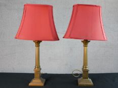 A pair of late 20th century Laura Ashley brass Corinthian column table lamps, with fluted stems