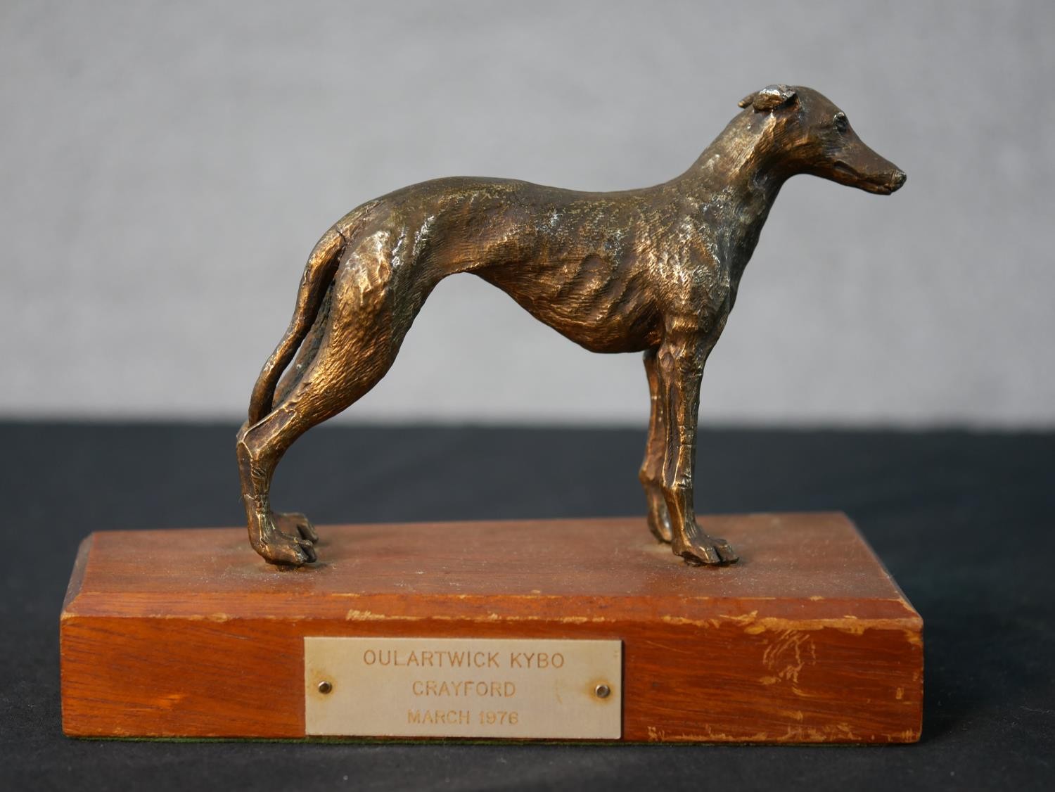 A mid 20th century cast brass Greyhound racing trophy with applied plaque. H.13 W.16.5 D.9cm