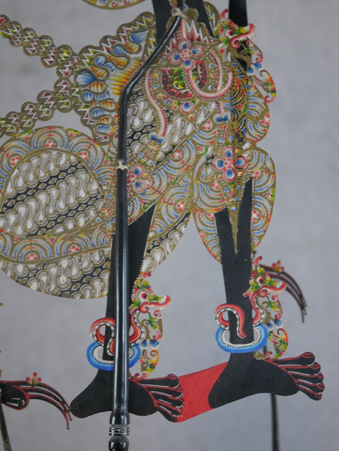 A carved and painted Javanese Wayang shadow puppet doll in silk clothing along with another Javanese - Image 6 of 6