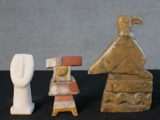 A collection of figures, including a white marble Cycladic head, a carved hardstone bird figure