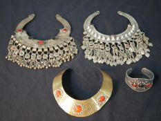 Three Tribal style torc necklaces with tassel decoration, set with glass cabochons and a similar