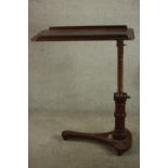 A late 19th / early 20th mahogany adjustable bed tray raised on triform base table terminating in