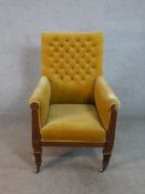 A William IV mahogany armchair, upholstered in mustard velour with a buttoned back, the arms