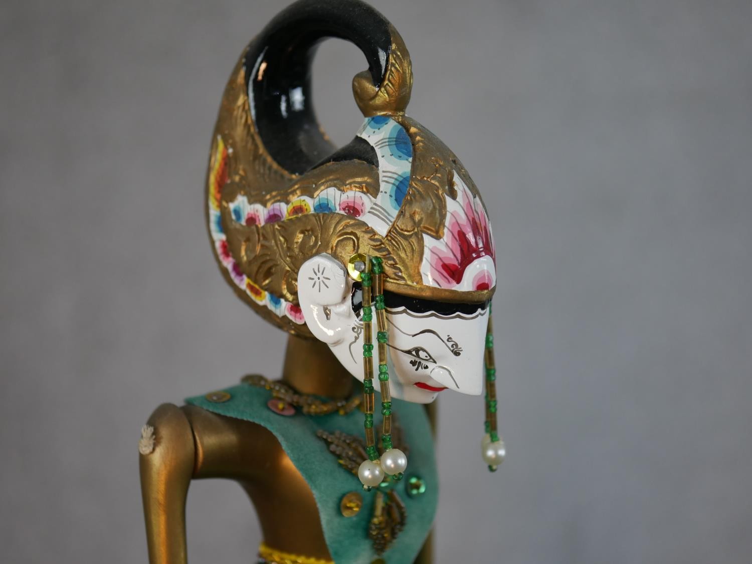 A carved and painted Javanese Wayang shadow puppet doll in silk clothing along with another Javanese - Image 3 of 6