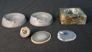 A collection of ashtrays and geode slices, including two Art Deco pewter race car ash trays and a