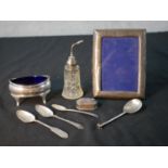 A collection of mixed silver items, including a silver and cut glass atomiser, a blue glass lined