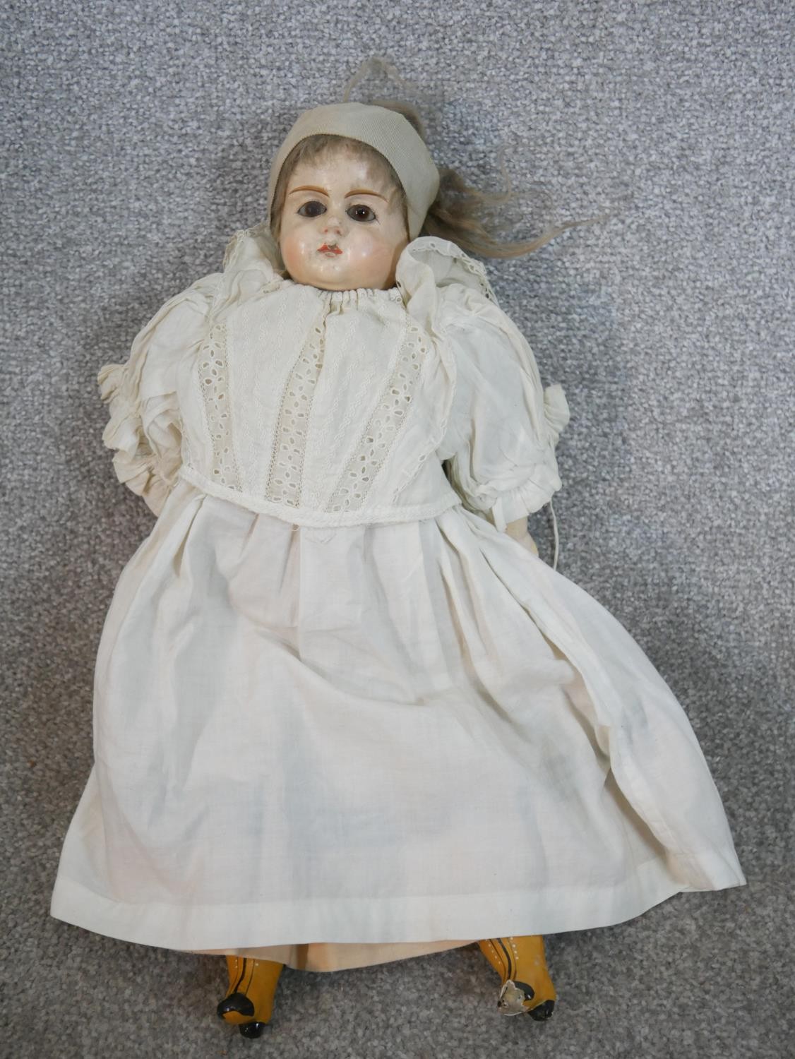 Two 19th century dolls, one craved and painted in a lace bonnet and dress with glass eyes, the other - Image 2 of 6