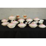 A 19th / early 20th century porcelain dinner set decorated with flowers on pink ground; together