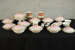 A 19th / early 20th century porcelain dinner set decorated with flowers on pink ground; together