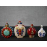 Four 20th century Chinese snuff bottles, one white porcelain with blue figural printed design, a