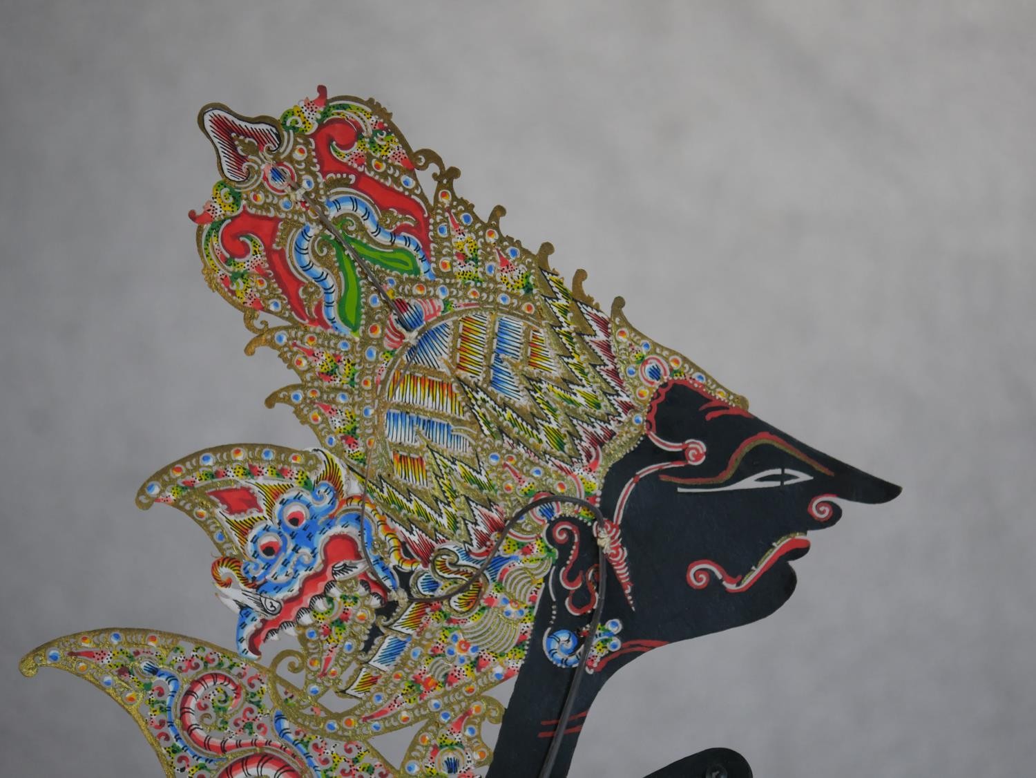 A carved and painted Javanese Wayang shadow puppet doll in silk clothing along with another Javanese - Image 5 of 6