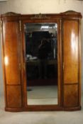 A late 19th century French triple wardrobe, with ornate gilt metal mounts, the central door