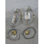 A pair of contemporary Hundi style glass storm lanterns, with brass fittings, the bell shaped