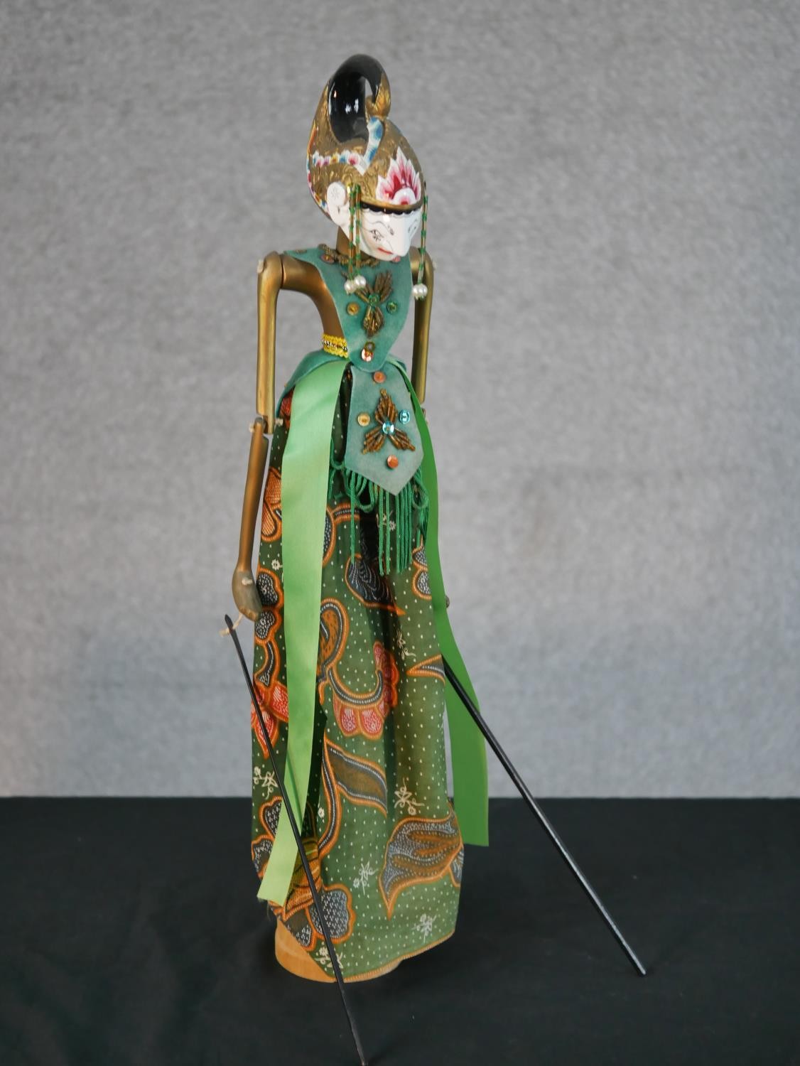 A carved and painted Javanese Wayang shadow puppet doll in silk clothing along with another Javanese - Image 2 of 6