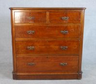 A Victorian walnut chest, the top with a moulded edge and rounded corners, over two short and