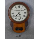A late 19th/early 20th century drop dial wall clock, the enamelled dial with Roman numerals marked