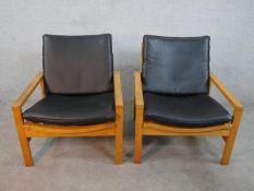 A pair of mid 20th century Cornwall - Norton teak open armchairs, model 10 / 11, with black