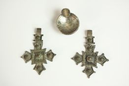 Two silver plated filigree wirework cross pendants along with a novelty miniature silver coin