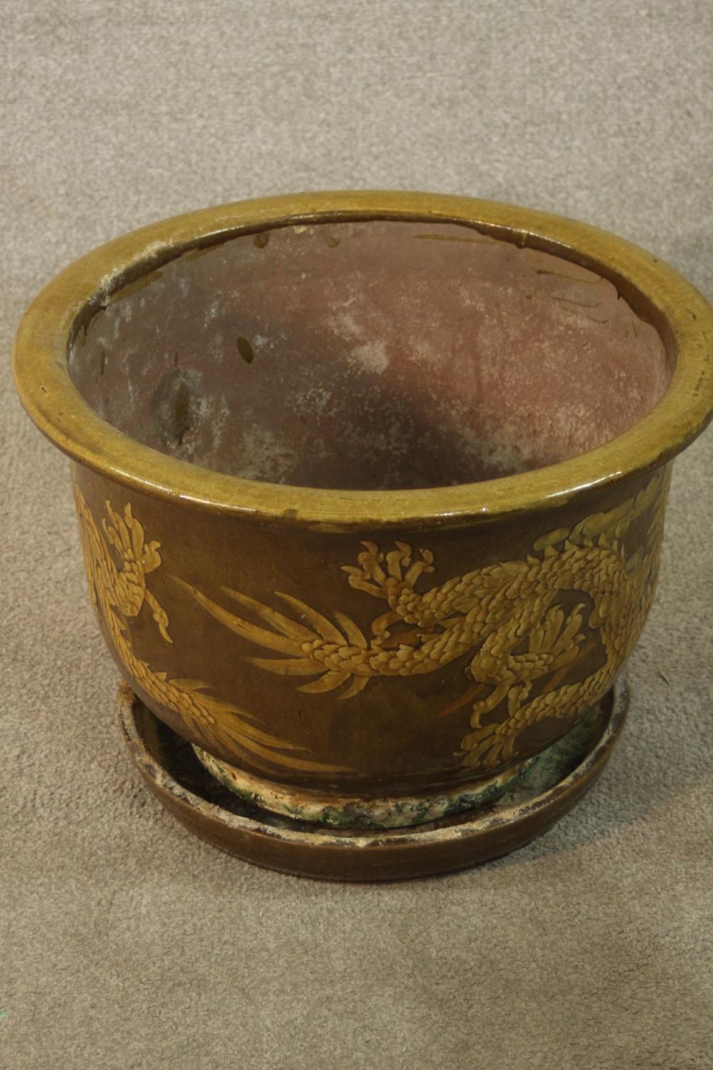 Chinese glazed pottery planter / jardinière and base with flying dragon decoration. H.39 Dia.49cm (