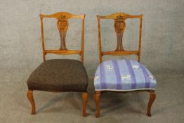 A matched pair of Edwardian walnut framed carved and pierced splat back nursing chairs with stuff