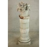 A late 19th / early 20th century white tin glazed pottery garden pedestal; moulded in the form of