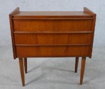 A mid century Danish teak chest of three long drawers raised on tapering supports. H.87 W.63 W.29cm