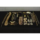 A large collection of mixed costume jewellery, including a fashion watch with faux pearl tassel