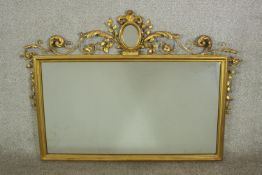 A 19th century gilt framed composition rectangular wall mirror with applied scroll and floral