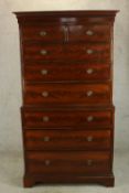 A George III mahogany chest on chest, the top section with dentil cornice with two short over